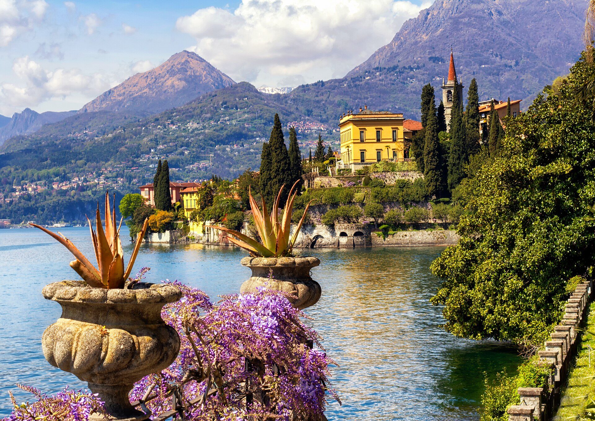 Stone urns and wisteria framing a villa on the shore of Lake Como at Varenna