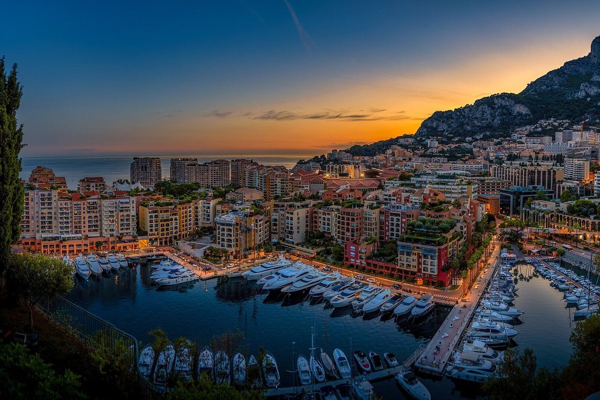Yachts in Fontvieille harbour below the cliffs of Monaco at sunset