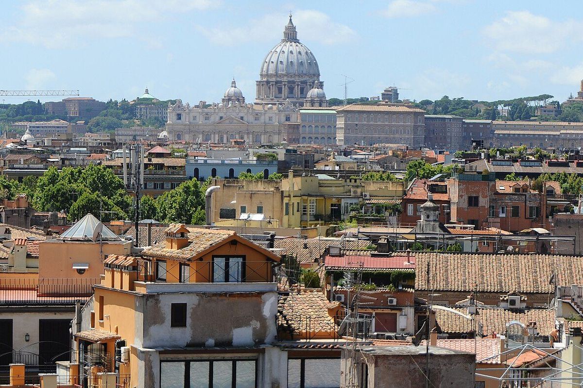 Terracotta rooftops of Rome with the dome of St Peter's Basilica beyond