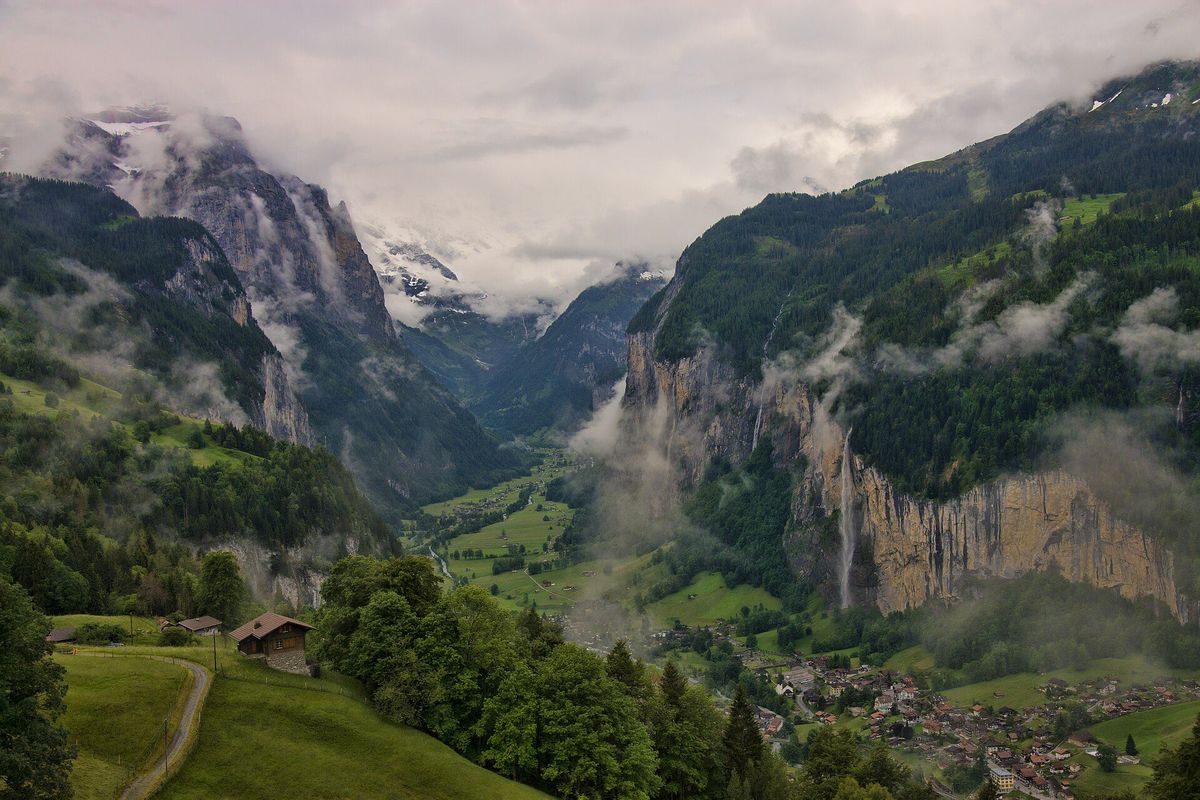 Mist drifting through the cliff-walled Lauterbrunnen valley in the Swiss Alps
