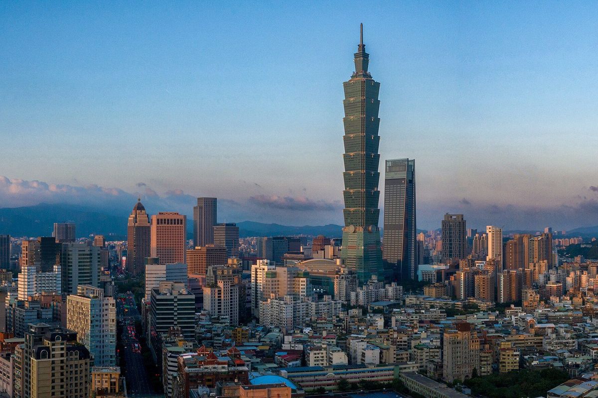 Taipei 101 rising above the city skyline against a clear sky