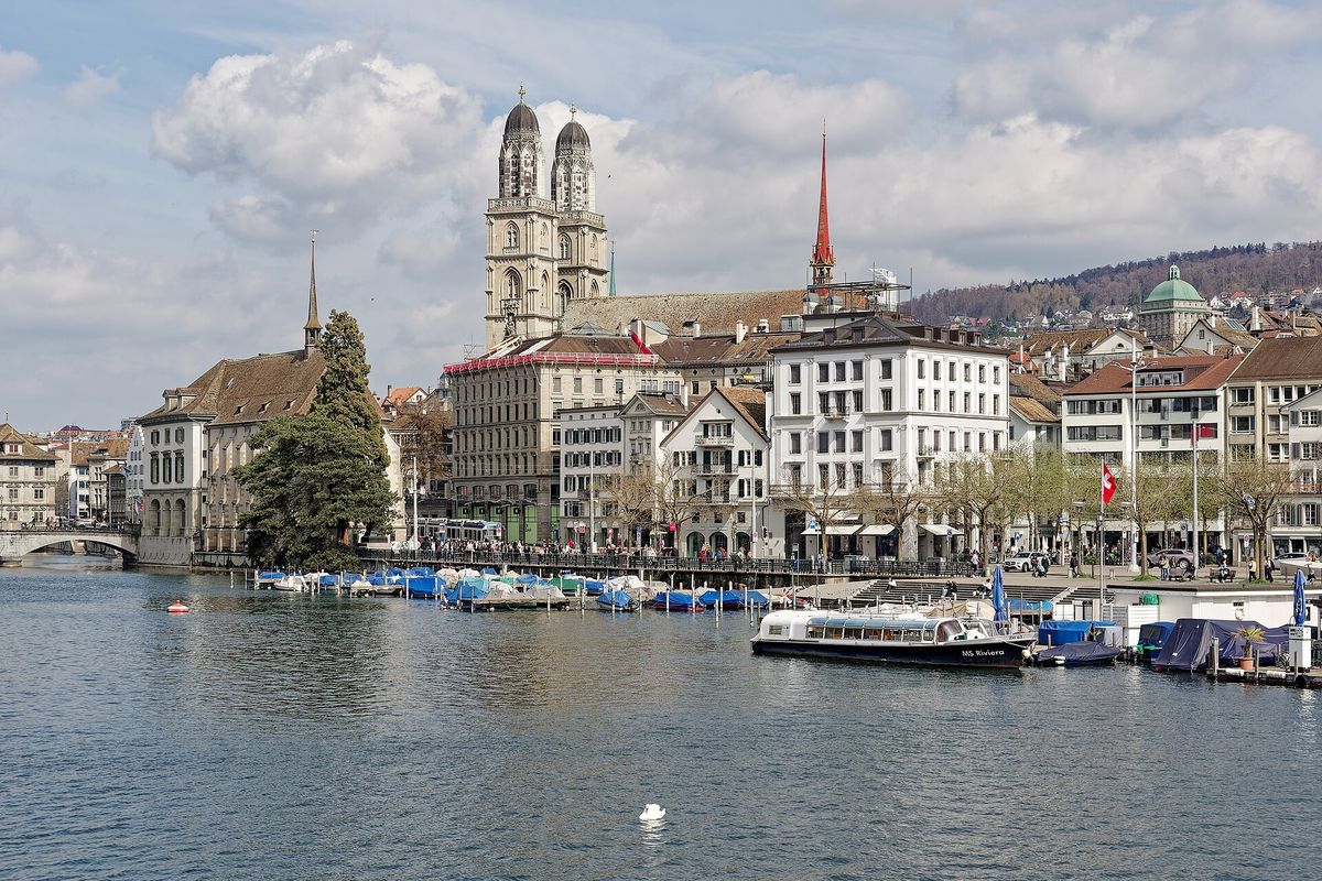 The twin towers of the Grossmünster above the Limmat and Zurich's old town, with the Fraumünster spire beyond